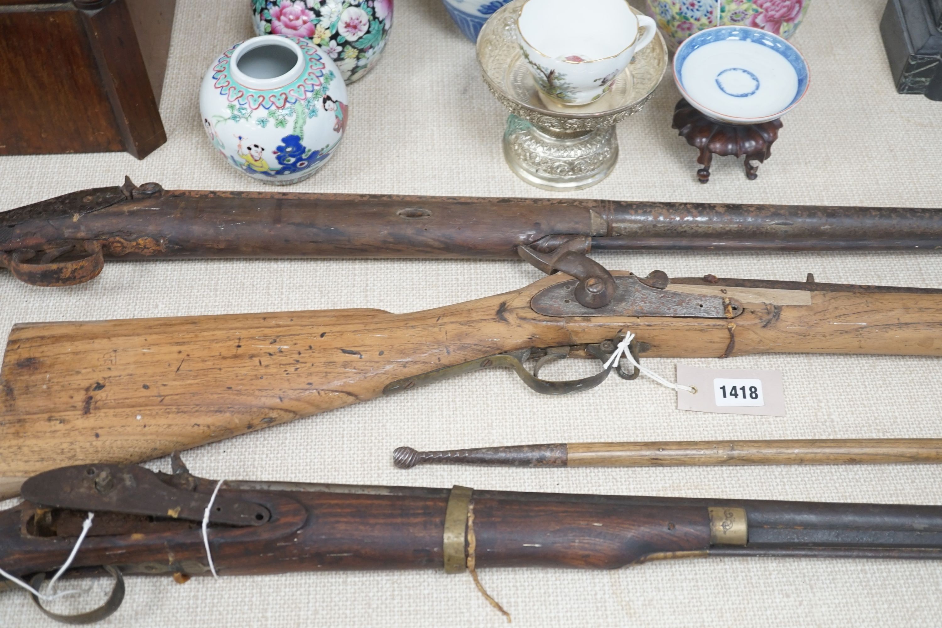 Three 19th century percussion rifles, (each in need of restoration), and a Belgian ramrod, longest 134 cms.